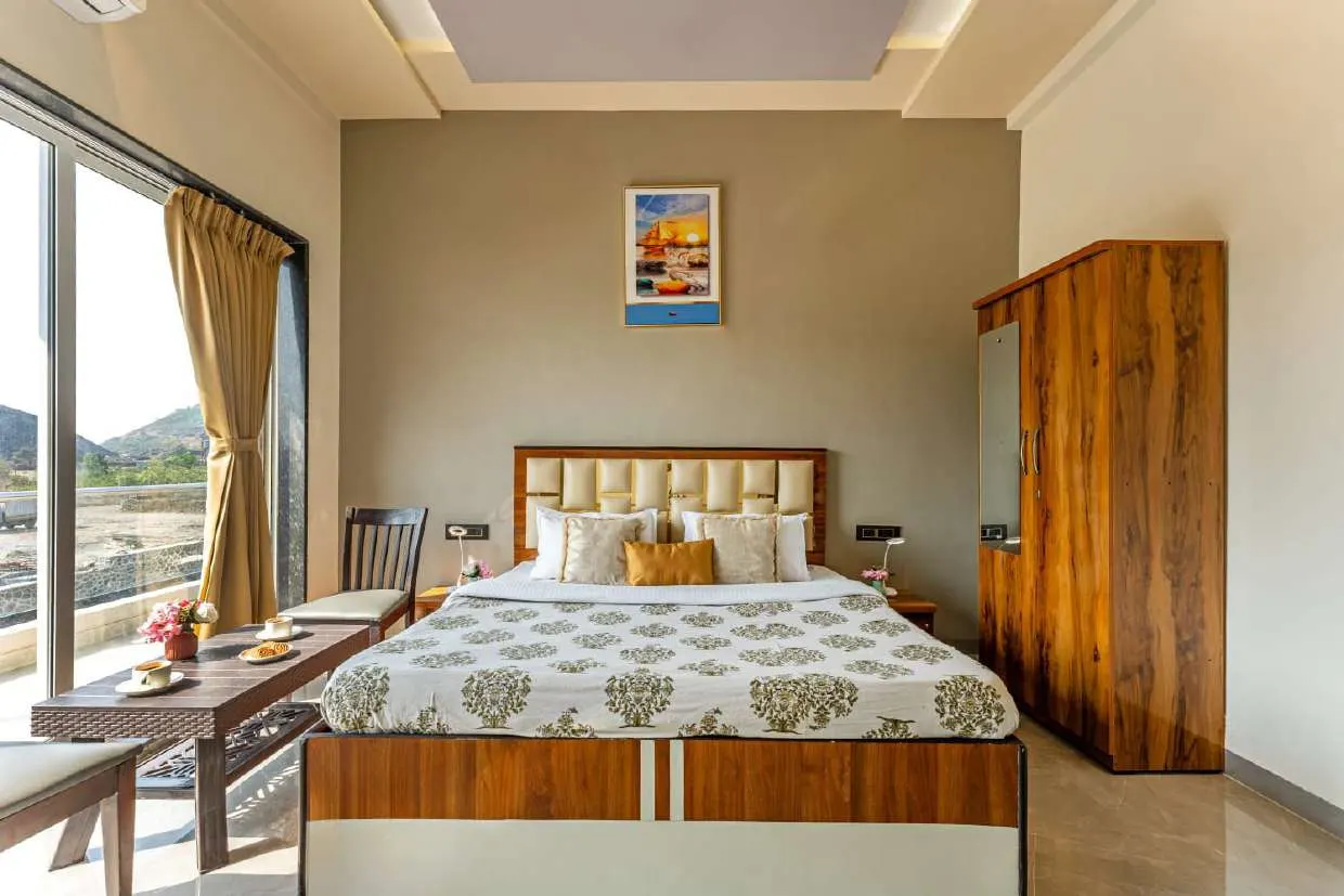 Air-conditioned bedroom with a hill view at Shuubh Kaustubh 5BHK Villa, Lonavala