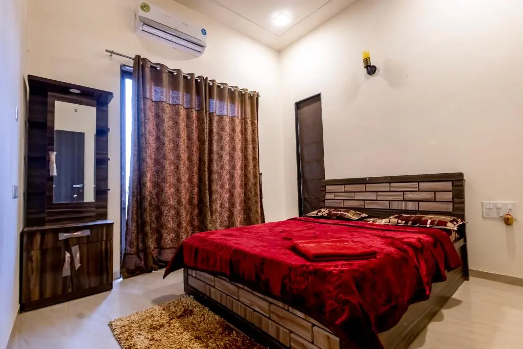 Air-conditioned bedroom in Rose Villa, a 4 BHK villa in Lonavala on rent