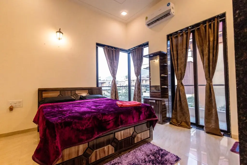 Air-conditioned bedroom in Rose Villa, a 4 BHK villa in Lonavala on rent