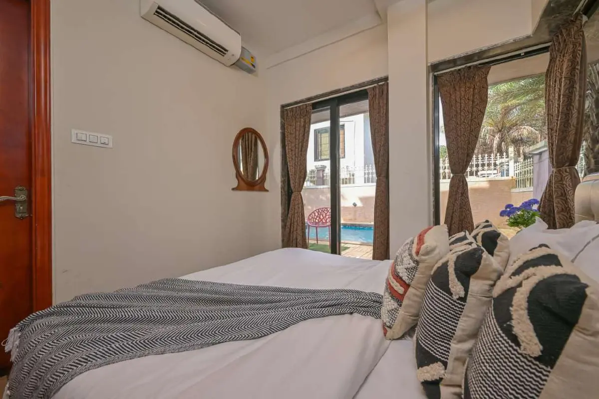 Air-conditioned bedroom in Shuubh Staycation 3BHK Villa, a 3 BHK villa in Lonavala on rent