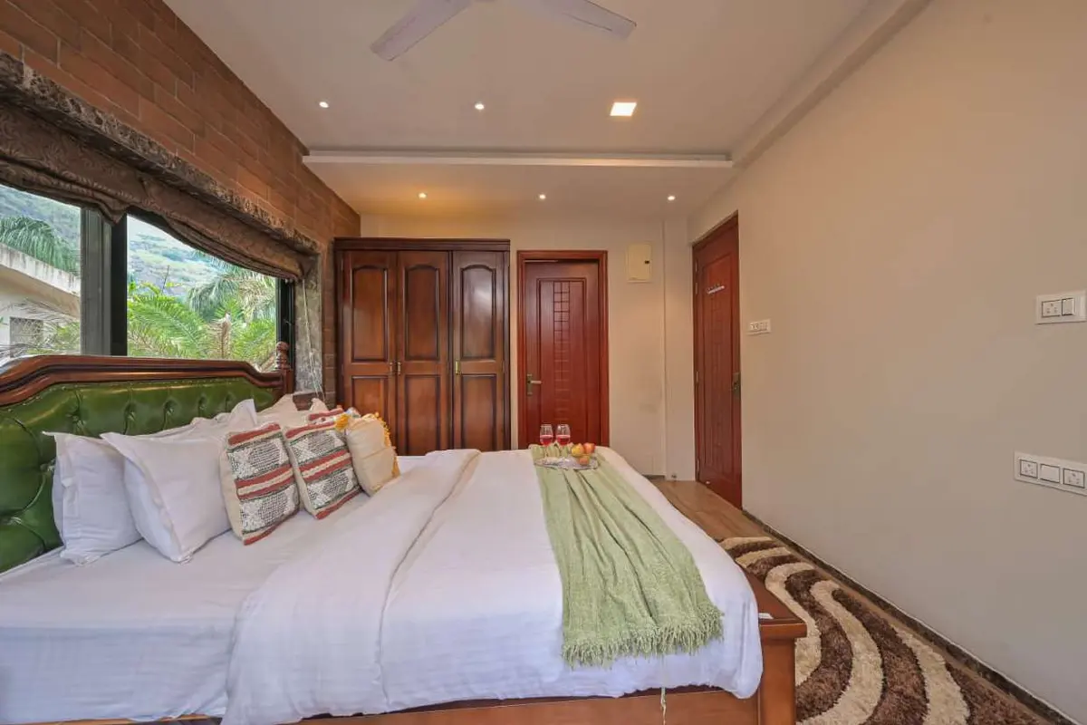Air-conditioned bedroom in Shuubh Staycation 3BHK Villa, a 3 BHK villa in Lonavala on rent
