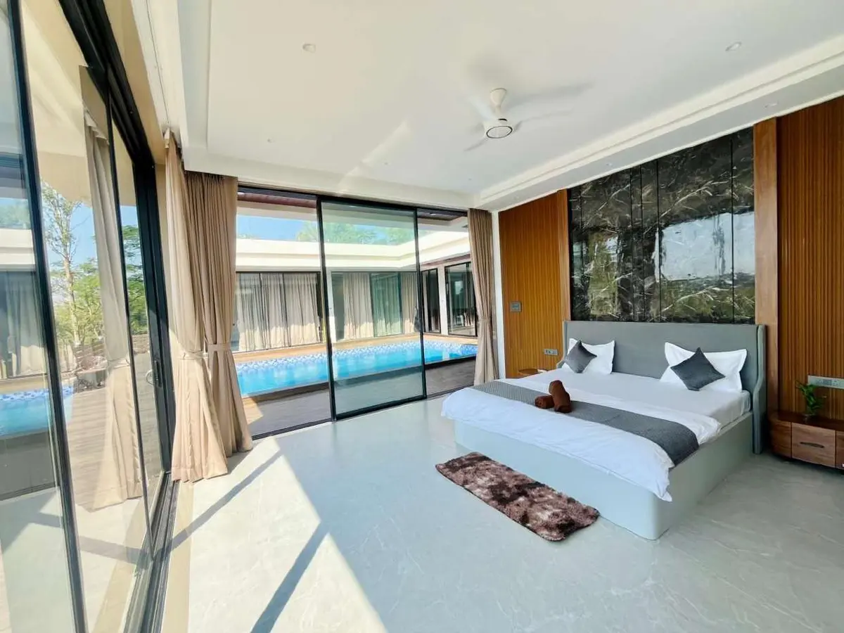 Air-conditioned bedroom in Vantara Villa, a 4 BHK villa in Lonavala on rent